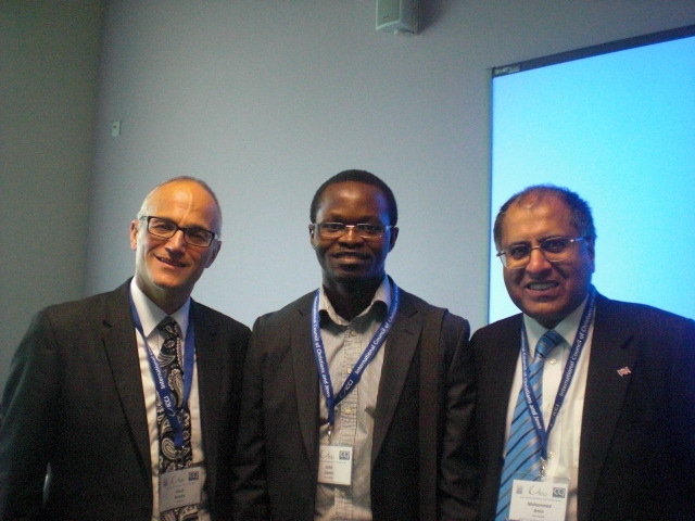 Photograph of David Berkley, Mohammed Amin and a conference participant